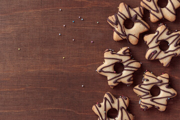 Fresh baked homemade star-shaped cookie with chocolate on the wooden table, copy space