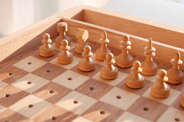Chess wooden pieces on the board. Position on the board.