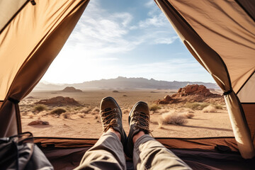 An outdoor traveler lies in an open tent, outdoors at sunset - Powered by Adobe