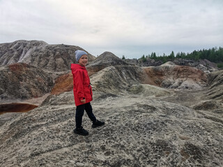 A boy on the background of the Ural Mars. An extraordinarily beautiful summer landscape with red...