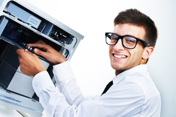 Computer tower, portrait and happy man repair studio hardware, electronics or check electrical machine. System maintenance expert, happiness and IT support fixing tech equipment on white background