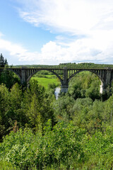 Railway bridge across the river in the south of the Kama region. The old Big Sars viaduct. The abandoned Oktyabrsky viaduct in the Perm Region. Russia.