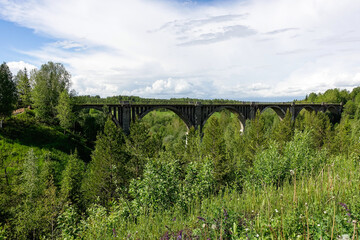 Railway bridge across the river in the south of the Kama region. The old Big Sars viaduct. The abandoned Oktyabrsky viaduct in the Perm Region. Russia.