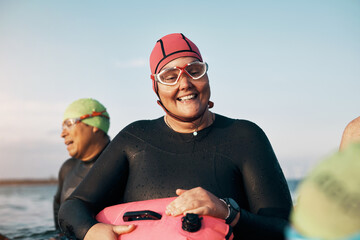 Smiling woman standing with friends in the ocean before a swim