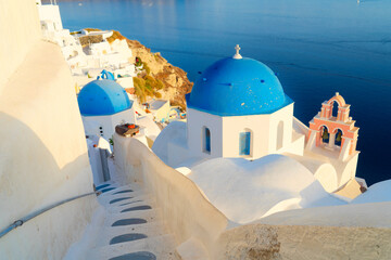 traditional greek village Oia of Santorini, with blue domes against sea and caldera, Greece, close...