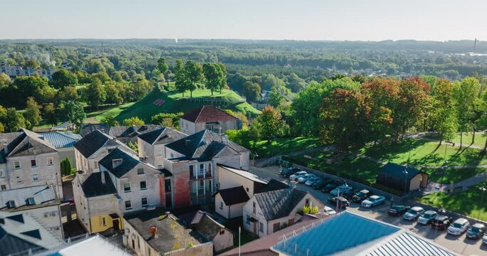 Beatiful forward moving hyperlapse of city Ukmerge locaten in center of Lithuania, Baltic States. Main subject is Mound. Sunny summer day. Fast moving traffic, Church, mound, central square visible.