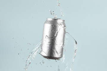 Aluminium beer or soda drinking can with water splash on light blue background