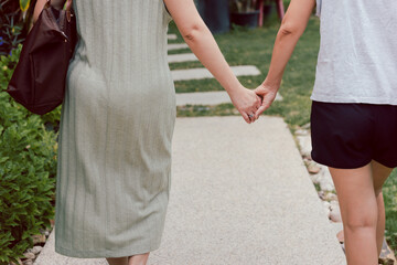 LGBTQ couple walking with hand holding hands.