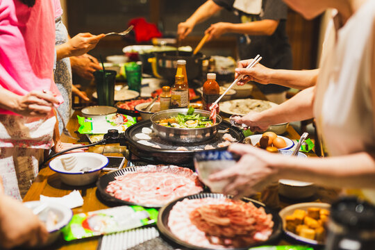 Group of friends cooking the Chinese shabu hotpot at home.