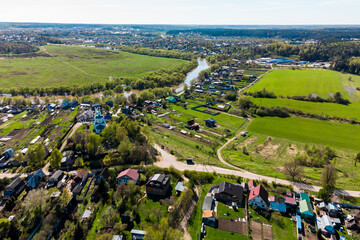 Bird's eye view of the countryside with houses and gardens near the river. Russia