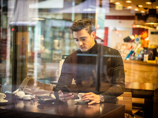 Attractive Man Drinking Coffee in a Bar