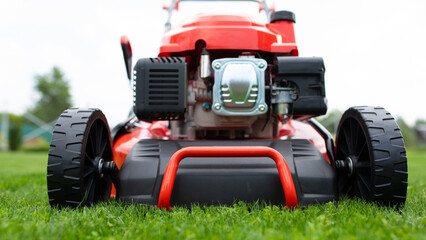 powerful self-propelled lawn mower, engine in garden