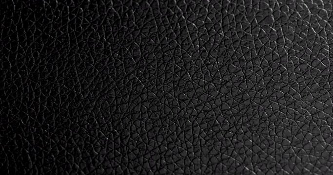 Black leather texture close up. Extreme close up footage.