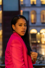 brunette girl in profile on a balcony
