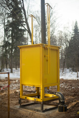 Gas equipment on street. Yellow technical structure. Urban infrastructure.