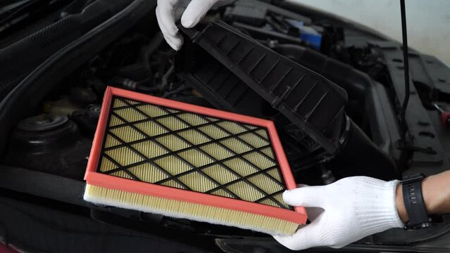 Replacing a new air filter in a passenger car,Automotive part concept.