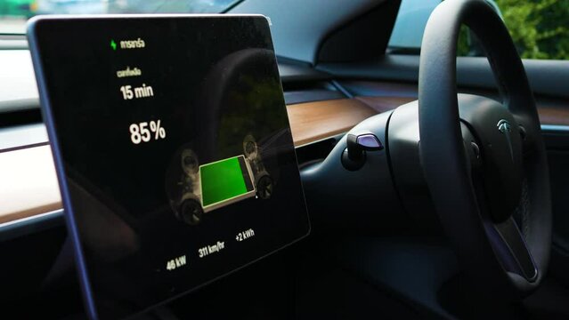 Ev car batterry charge screen inside car at electrict station eco transport concept