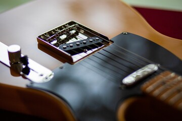 a guitar sits on the top of the table and has a box on its neck