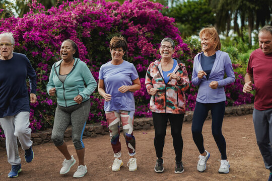Senior people having fun doing sport exercise together at city park - Fit elderly friends outdoor - Healthy lifestyle concept