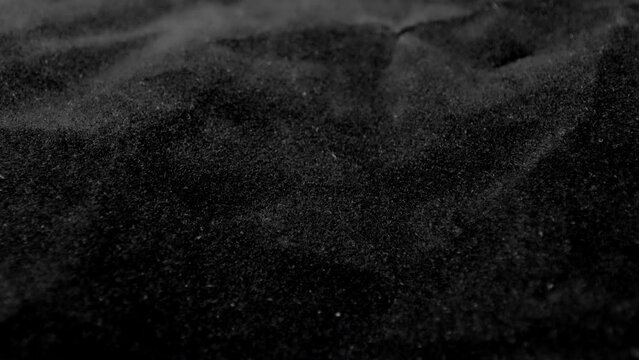 Crumpled rough dark surface. Black crumpled texture surface. Used as a background and texture.