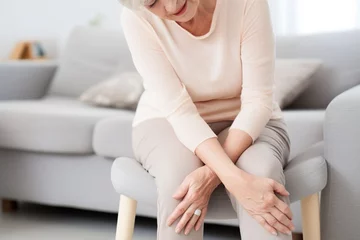 Fotobehang Old woman having knee pain © Salsabila Ariadina
