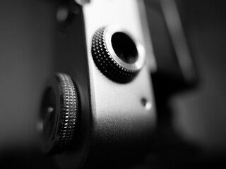 Grayscale shot of the small parts of an old vintage camera