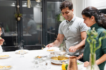 Husband and wife putting food on plates