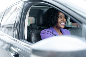 Smiling woman driving car