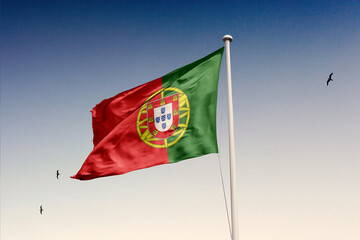 Portugal flag fluttering in the wind on sky.