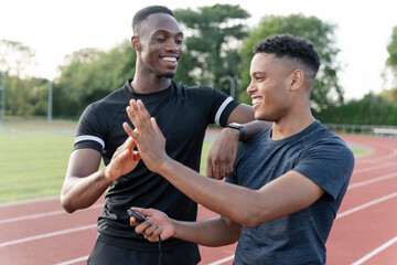 Portrait of two athletes doing high five