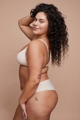 Studio portrait of smiling young woman wearing lingerie