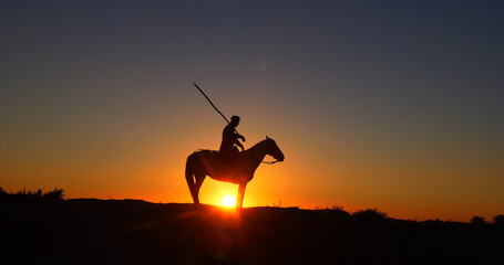 Man on his Camargue Horse at Sunrise, Manadier in Saintes Maries de la Mer in Camargue, in the...