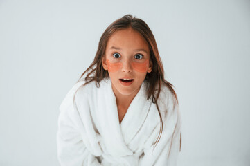 Positive and surprised facial expression. With eye patches. Conception of beauty. Young girl is in...