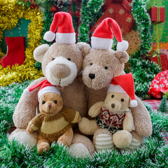 Teddy bear family Christmas portrait (parents and two children wearing Santa hats)  