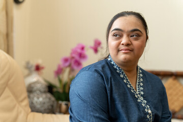 Portrait of young woman with down syndrome at home