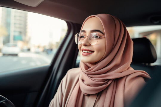 Beautiful woman wearing hijab sitting in the car