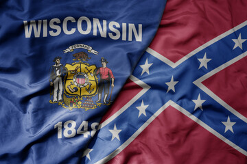 big waving colorful confederate jack flag and flag of wisconsin state .