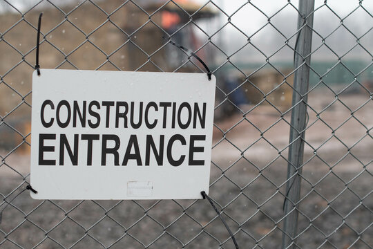Construction site sign on fence and machinery working background, copy space image background