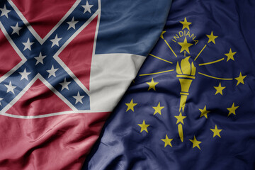 big waving colorful national flag of indiana state and flag of mississippi state .