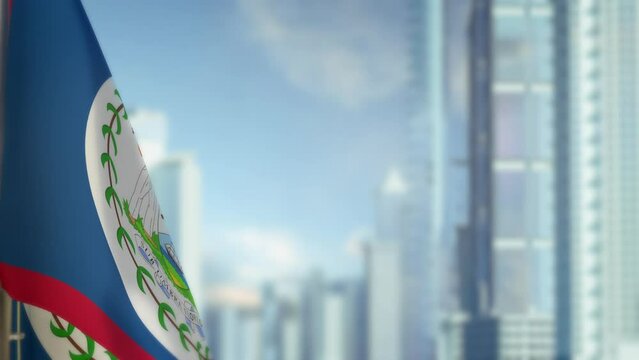 hanging Belize flag on city backdrop with blue sky