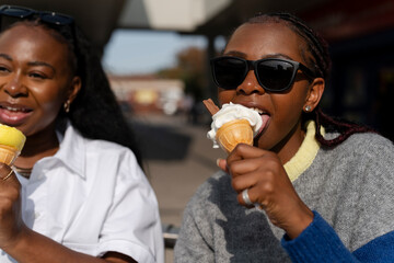 Young female friends eating ice cream