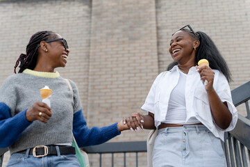 Young female couple eating ice cream