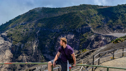 COSTA-RICA VOLCANO MOUNTAINS copy space travel background image, natural light landscape, white man tourist enjoying the view - Powered by Adobe