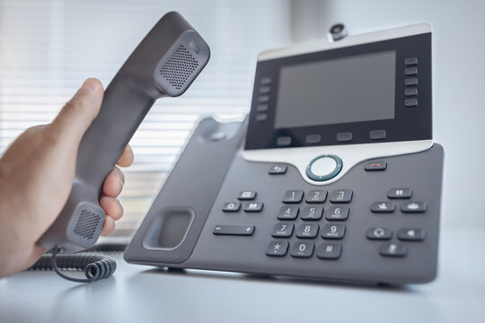 Dialing a telephone in the office concept for communication, contact us and customer service support