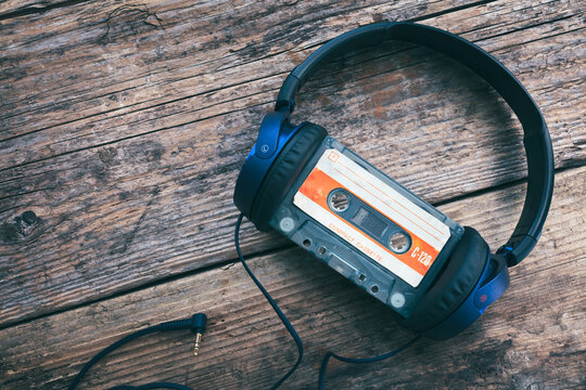 Audio compact cassette tape and headphones background
