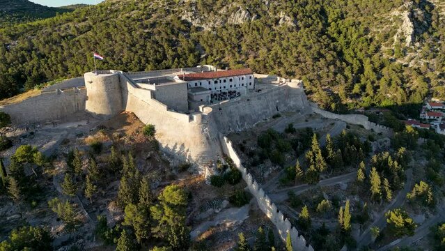 Aerial drone view around the Spanish Fortress at Hvar, Croatia at sunset.