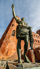 Turin, Piedmont, Italy - November 3, 2023: Statue of the emperor Augustus near the remains of the...