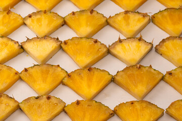 Pineapple juicy yellow slices on a white background.