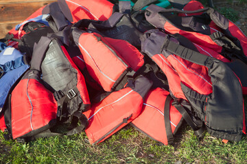 Life jackets piled up on the grass