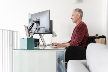 Mature man working on computer at home